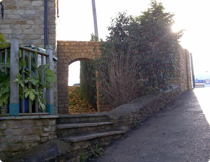 Adding coping stones to a 19th century wall.